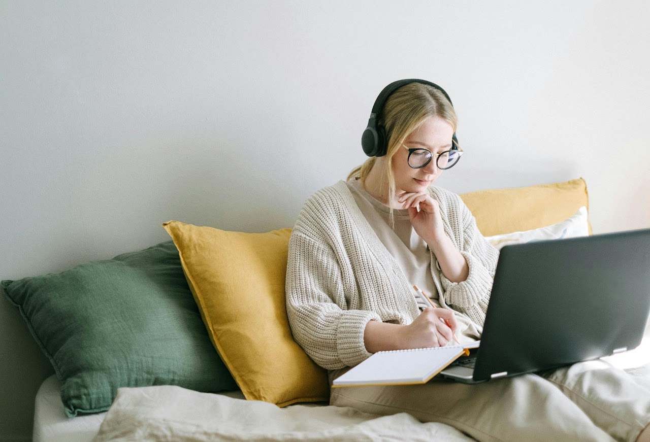 Person learning online with laptop and headphones